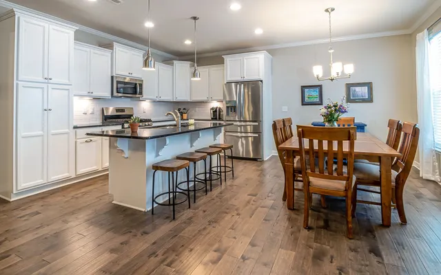 A bright kitchen with recessed ceiling lights, island pendants and under-cabinet lighting.